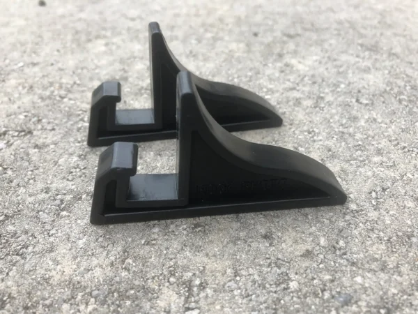 A pair of black plastic stands on the ground.