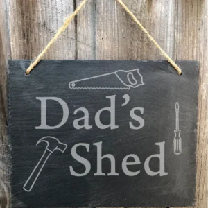 A sign that says dad 's shed with tools on it.