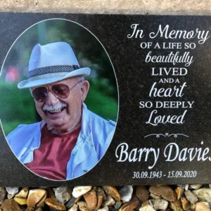 A memorial plaque with a picture of barry davies.