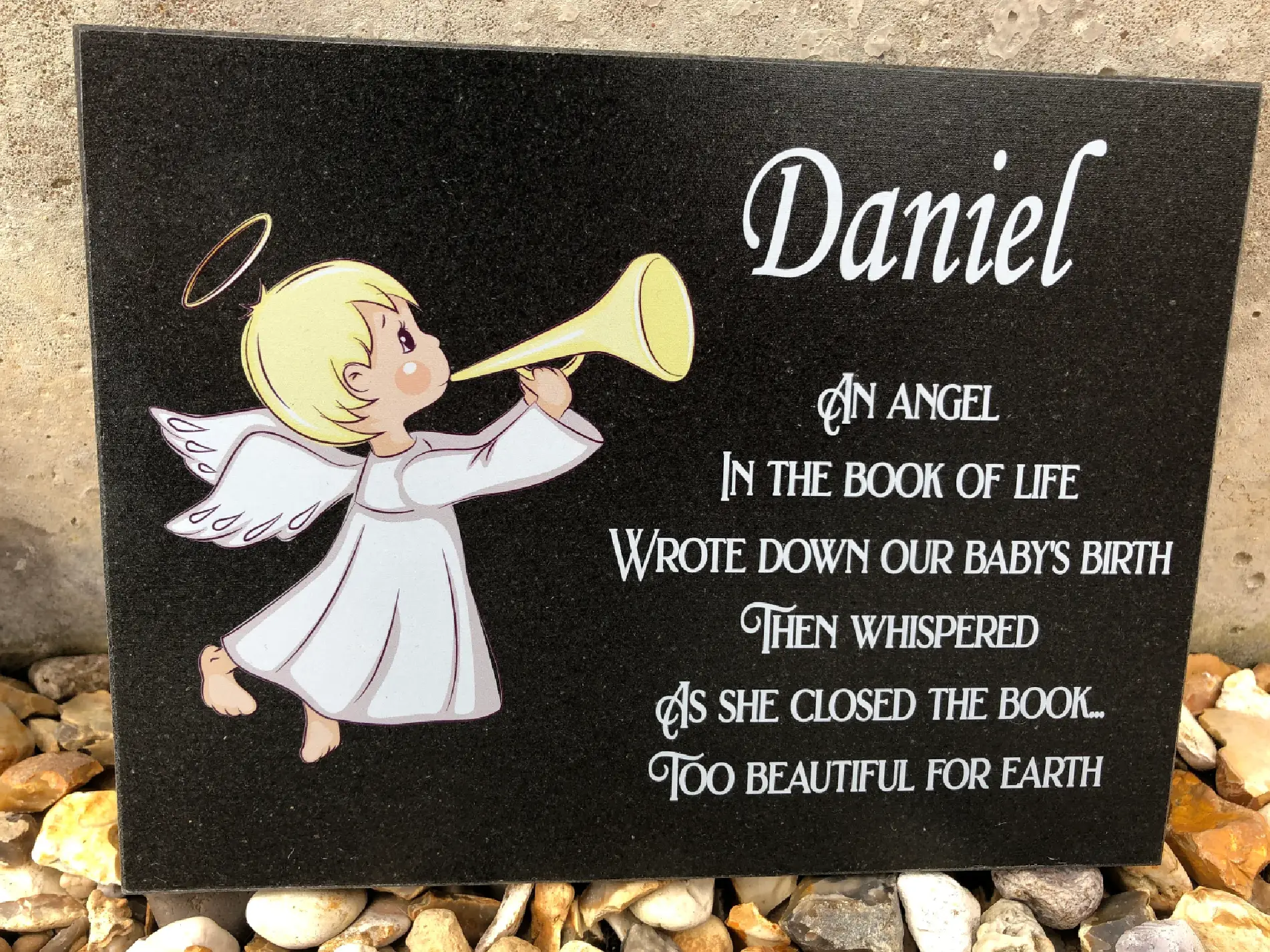 A plaque with an angel holding a horn.