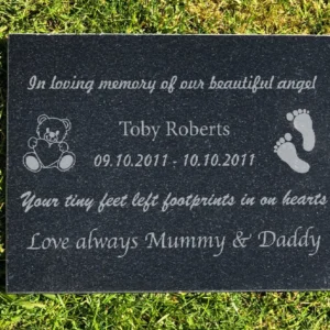 A memorial plaque with the name of a child and date.