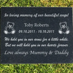 A memorial plaque with the names of two children.