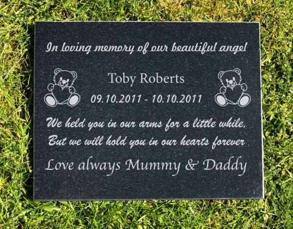 A memorial plaque with the names of two children.