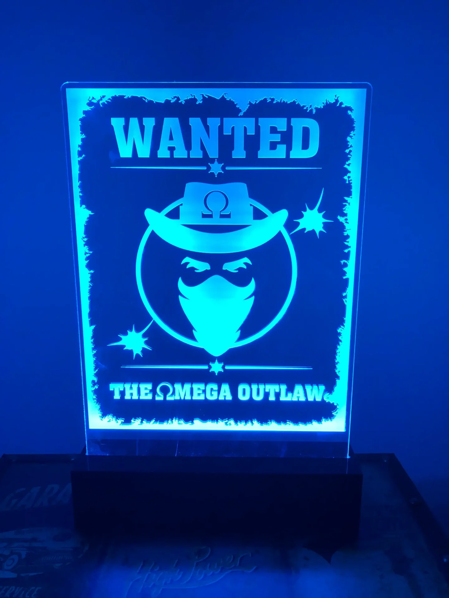 A wanted poster is shown in the light.