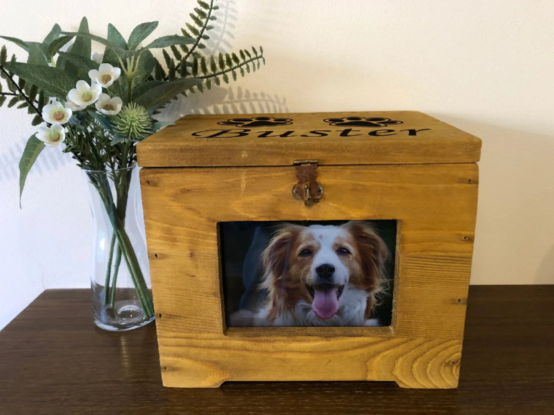 A wooden box with a picture of a dog in it.